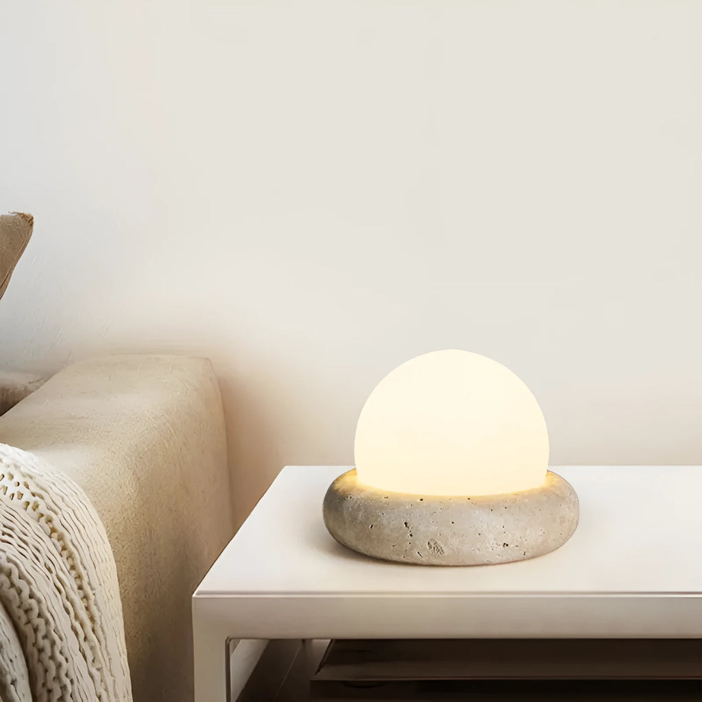 Cream coloured remote control bedside night lamp with yellow cave stone light on wooden table