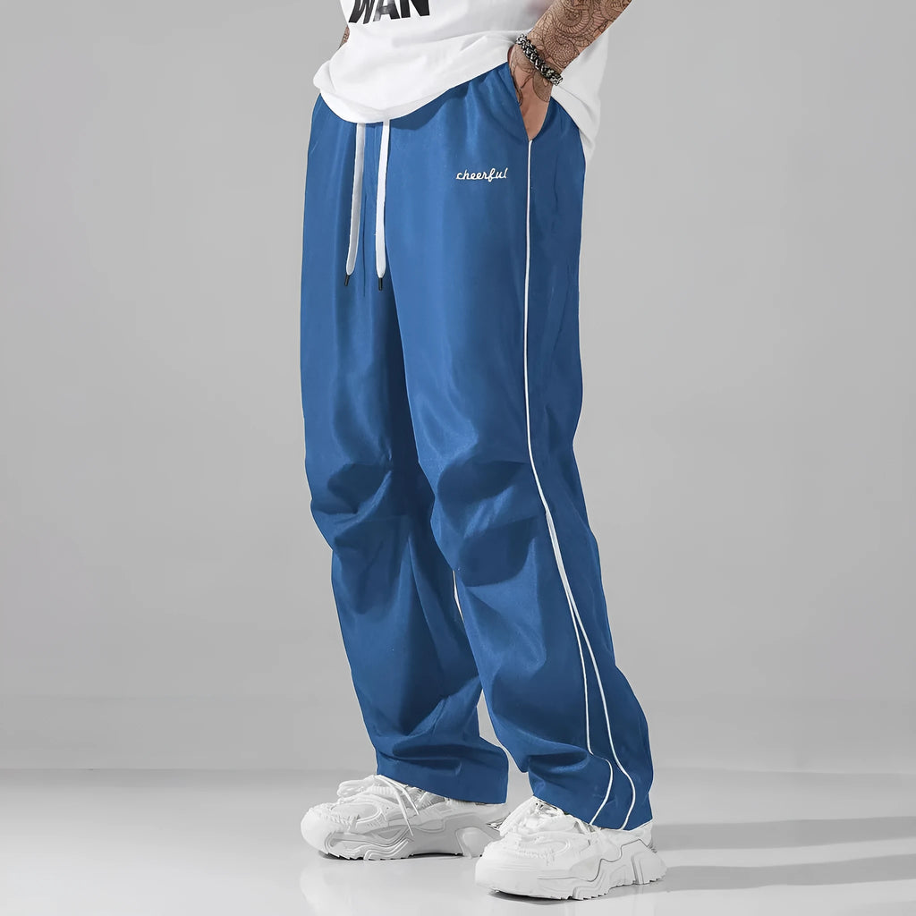 High street charging paratrooper pants for teenagers in straight leg style, available in multiple colours like black and dark green