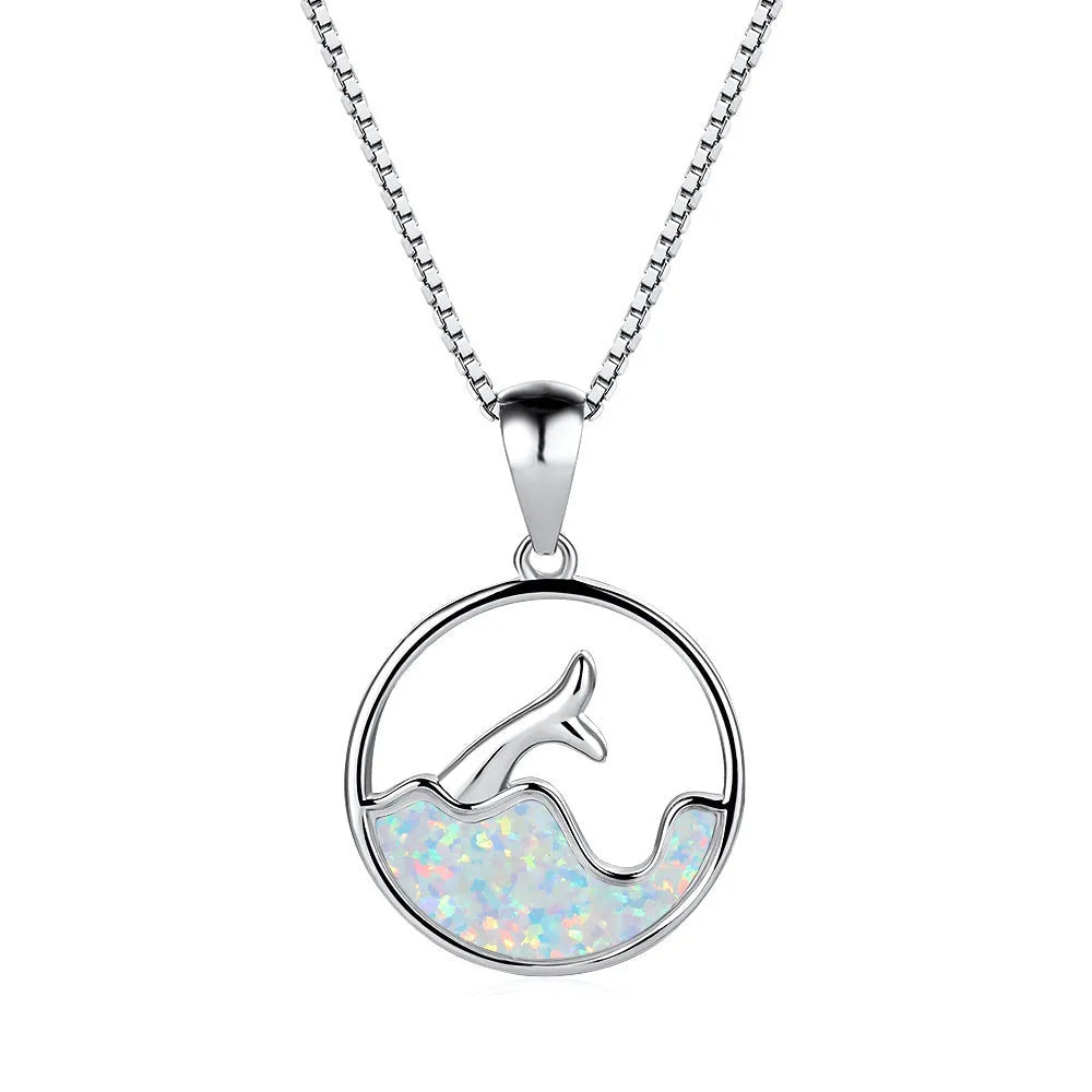 White gold electroplated geometric fishtail necklace pendant with a round blue opal stone.