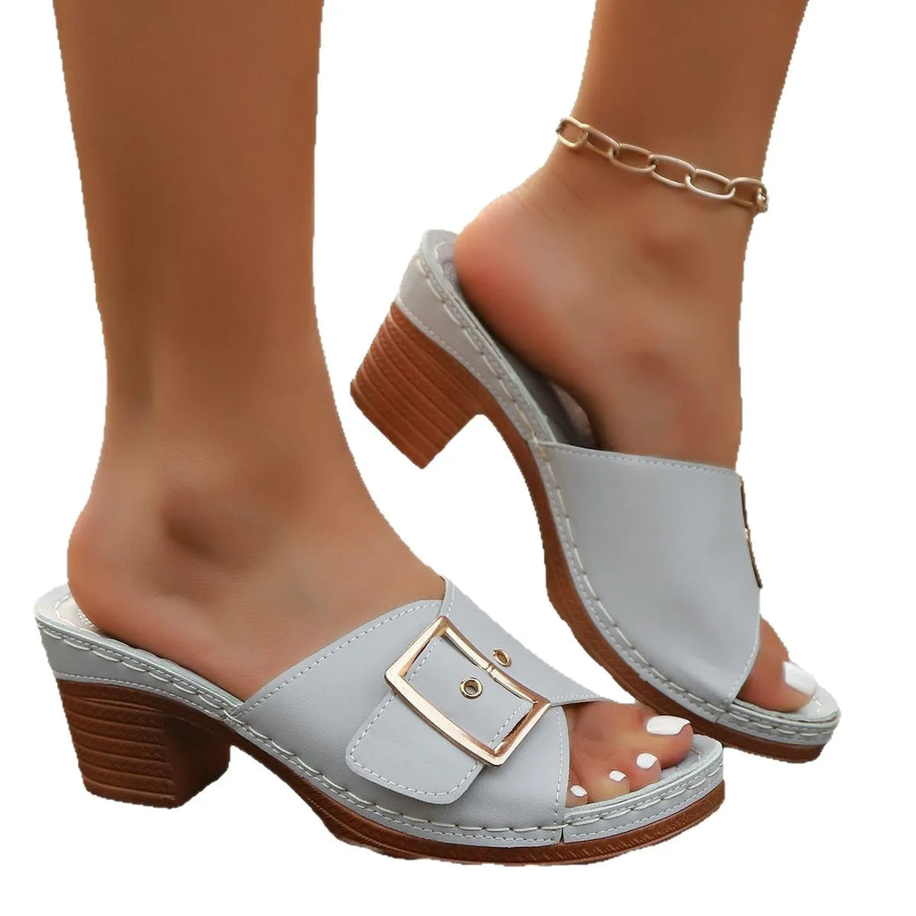 Women's black and light blue chunky heel slippers with metal buckle detail and round toe