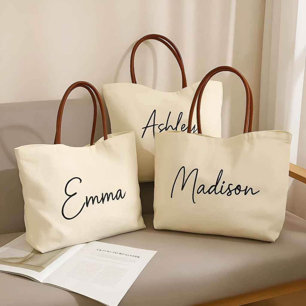 Beige white canvas tote bag with a front zip pocket and sturdy shoulder straps laid flat.