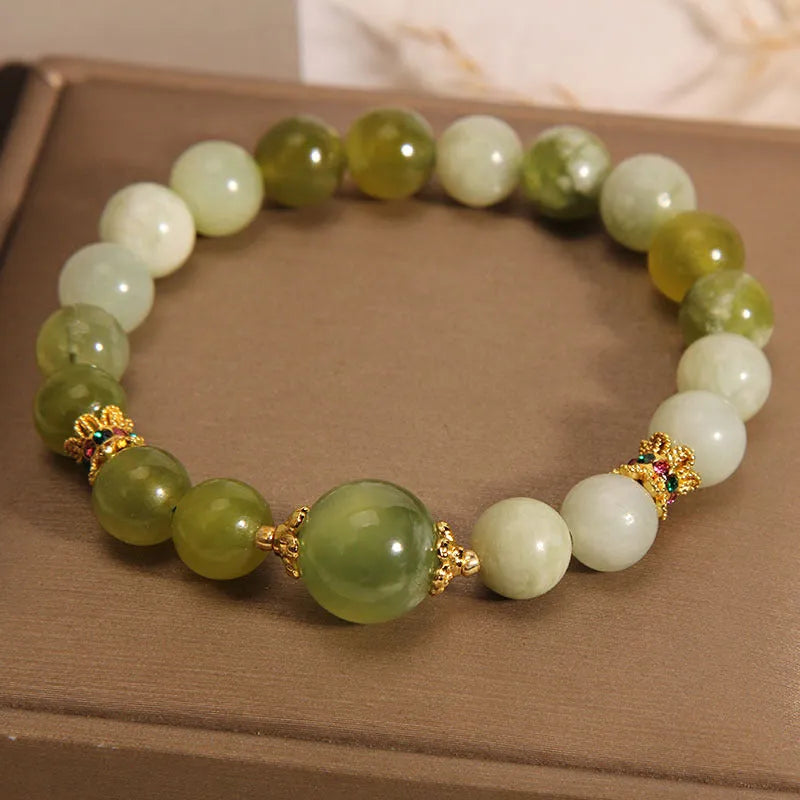 Women's bracelet made of green Xiuyan jade with an original sweet Mori style design.