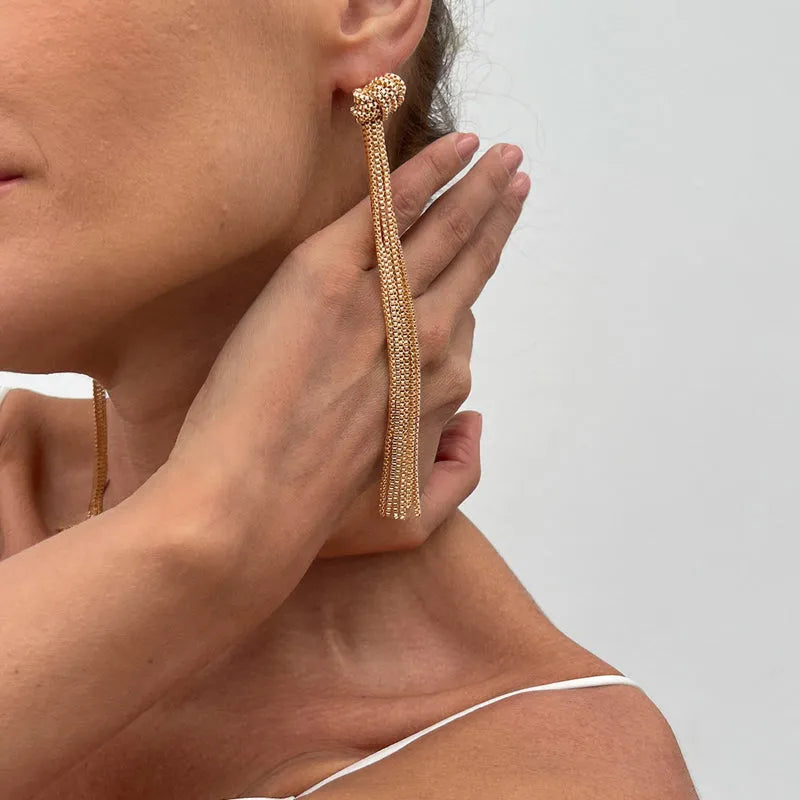 Simple Y-shaped metal tassel necklace with minimalist understated style, colour Gold, on display with matching earrings.