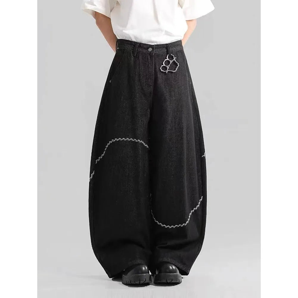 Black straight-leg denim trousers with micro-elastic fabric and mid-waist zip fly