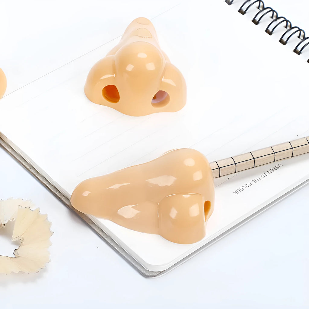 Flesh colour geometry plastic pencil sharpener with big nostril hole measuring 58x45x30mm