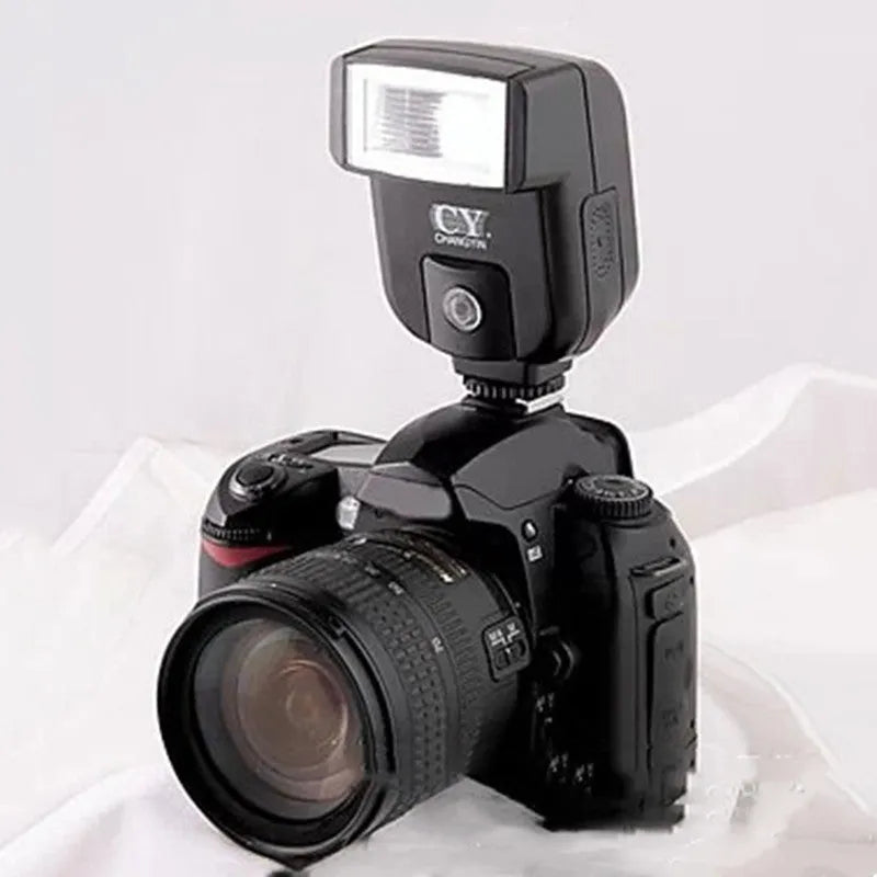 Compact SLR camera flash accessory unit shown tilted on a camera hot shoe, showcasing its 90-degree adjustable head.