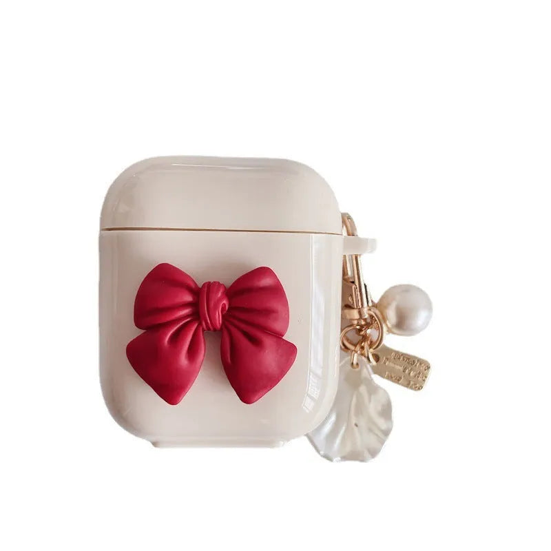 Beige red bow shell coloured TPU clamshell case cover for Apple AirPods charging case.