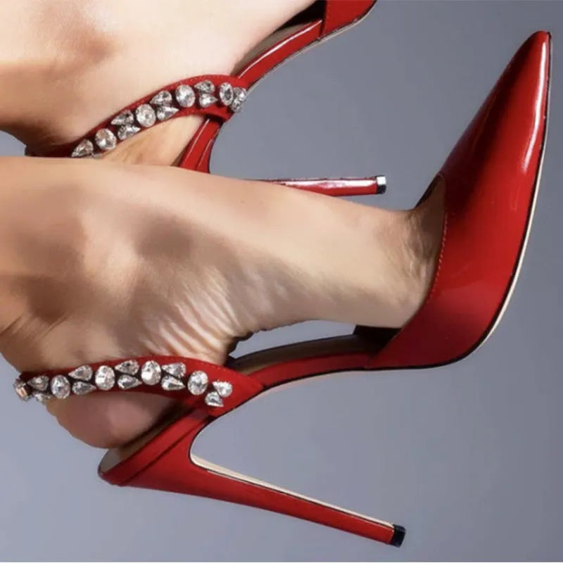 Women's black patent leather pointed toe high heel sandals with rhinestone decoration on the side.