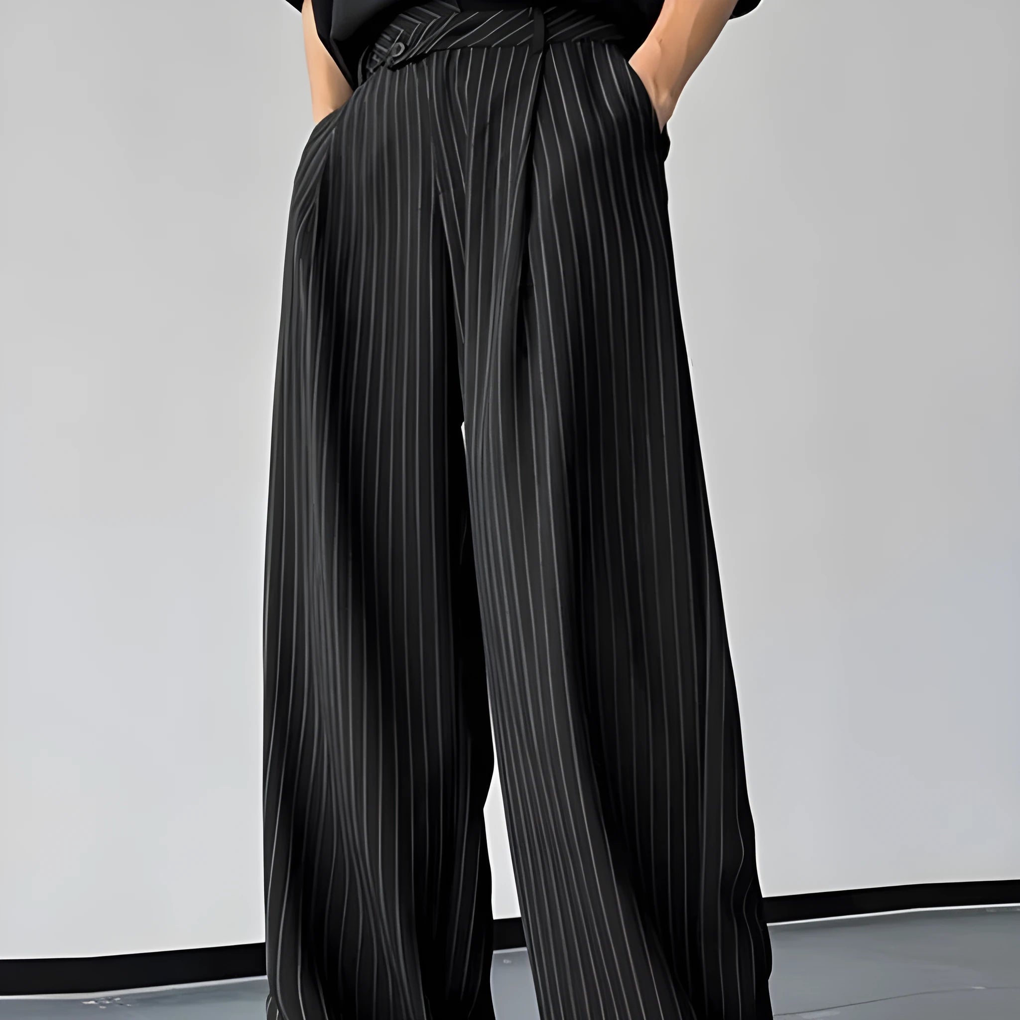 Black men's trousers with vertical striped pleated design showing elastic casual wear