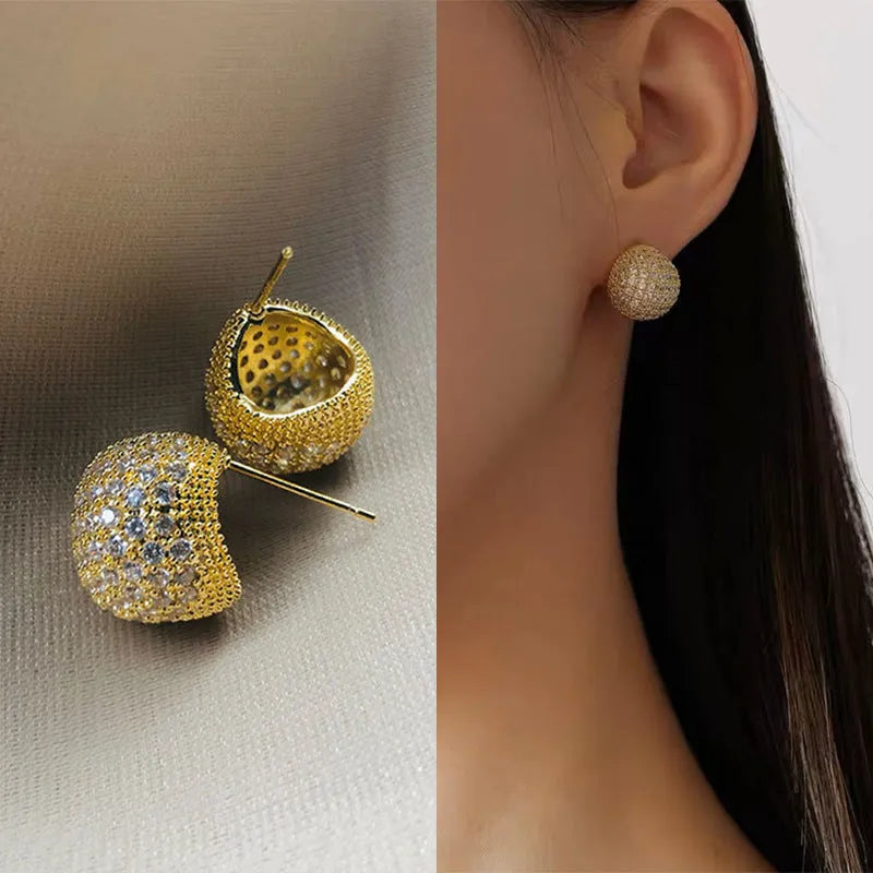 Gold or white geometric drop-shaped clip earrings with spherical bead elements