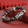 Close-up of a colourful handcrafted Chinese bracelet with snake lucky beads and auspicious patterns.