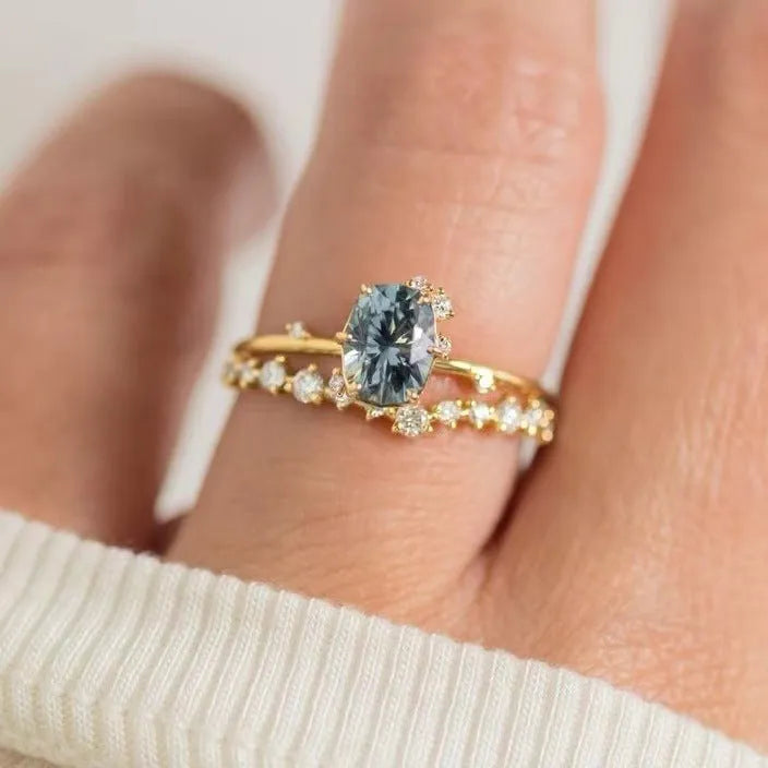 Gold-plated floral ring with green zircon stone, shown on female hand