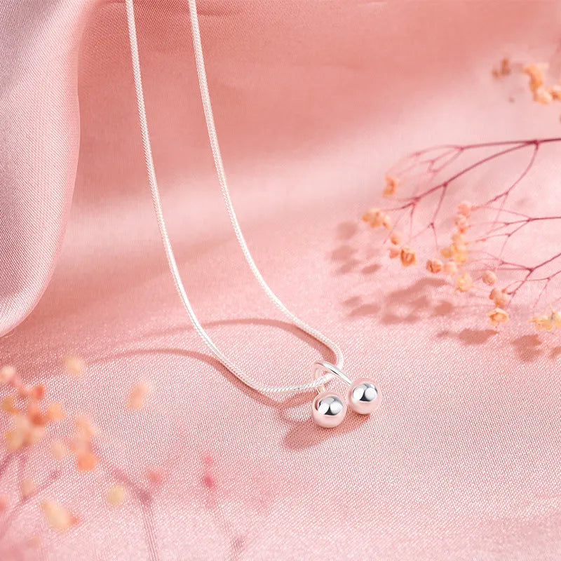 Silver cherry pendant necklace with adjustable snake bone chain on a 21cm to 50cm range.