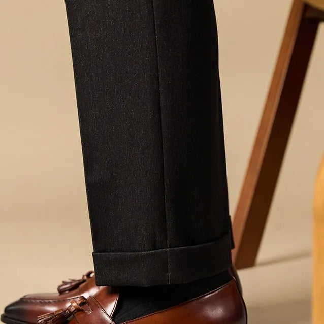 Men's black polished leather tassel loafers with a pigskin lining and rubber sole