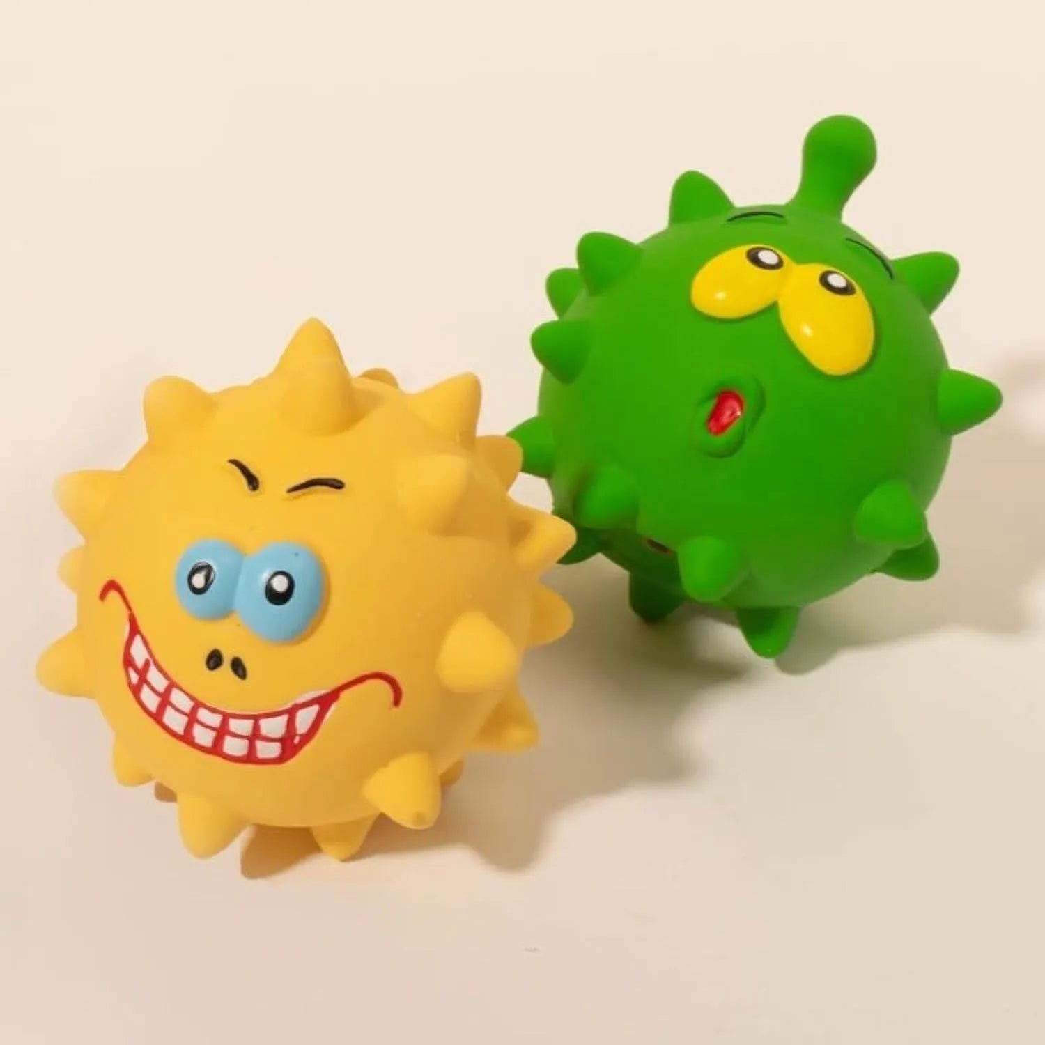 Four colourful natural latex dog balls with squeaky features and cute animal faces