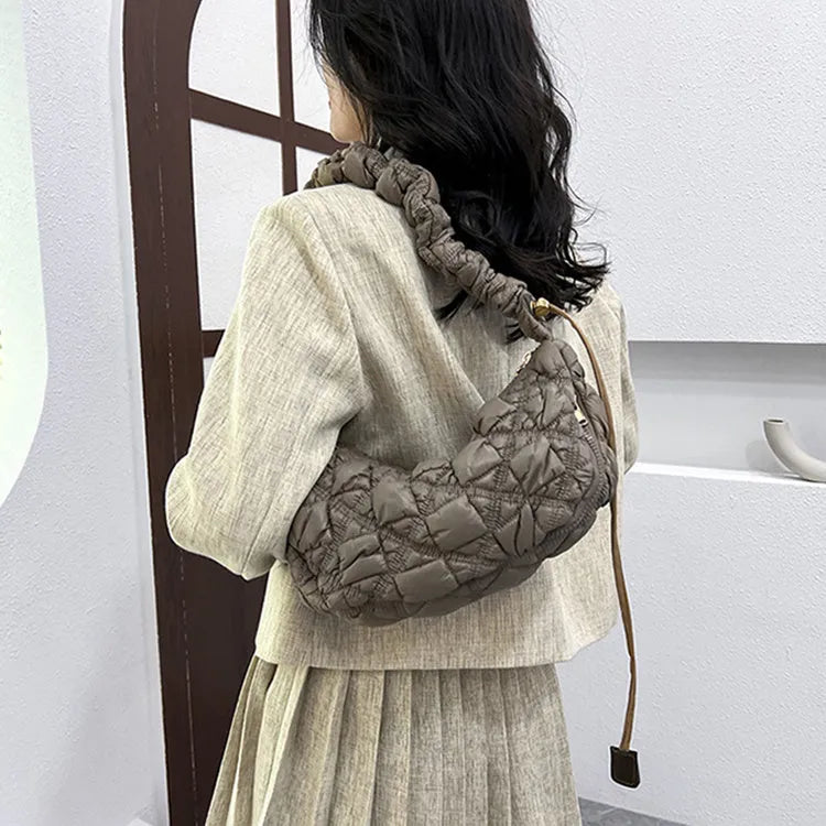 Women's lightweight nylon underarm messenger bag in a solid colour with an adjustable long shoulder strap.