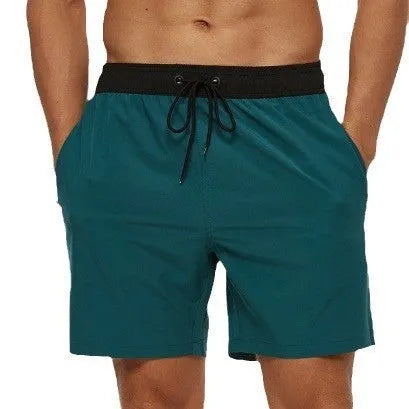 Men's blue athletic shorts with stitching waist detail and zipper pockets for running and fitness