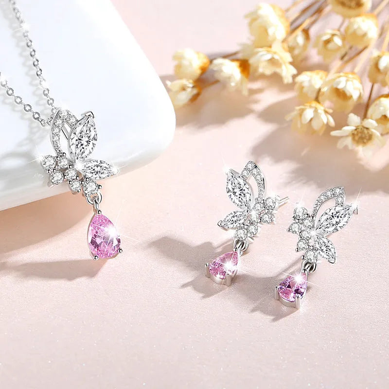 A pair of silver butterfly stud earrings with clear crystal details on a white background.