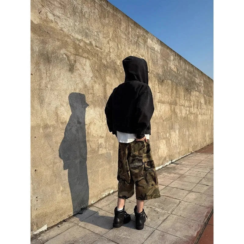 Men's retro patch ripped camouflage cropped jeans showing loose straight leg fit and distressed detailing