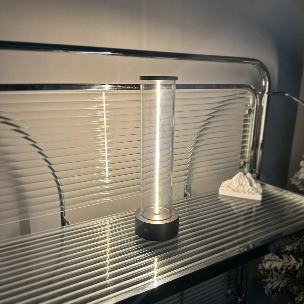 Slender white USB LED light strip with magnetic base on a metal surface