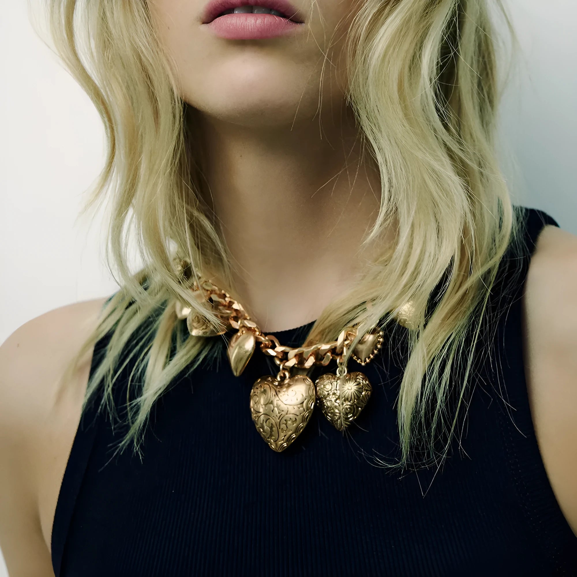 Exaggerated carved heart pendant necklace in gold finish with adjustable chain