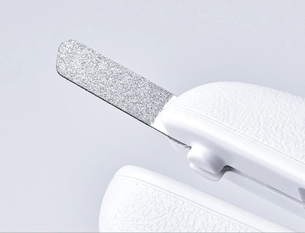 White pet nail clippers with LED light, transparent anti-splash guard, and leather-like handle on a table