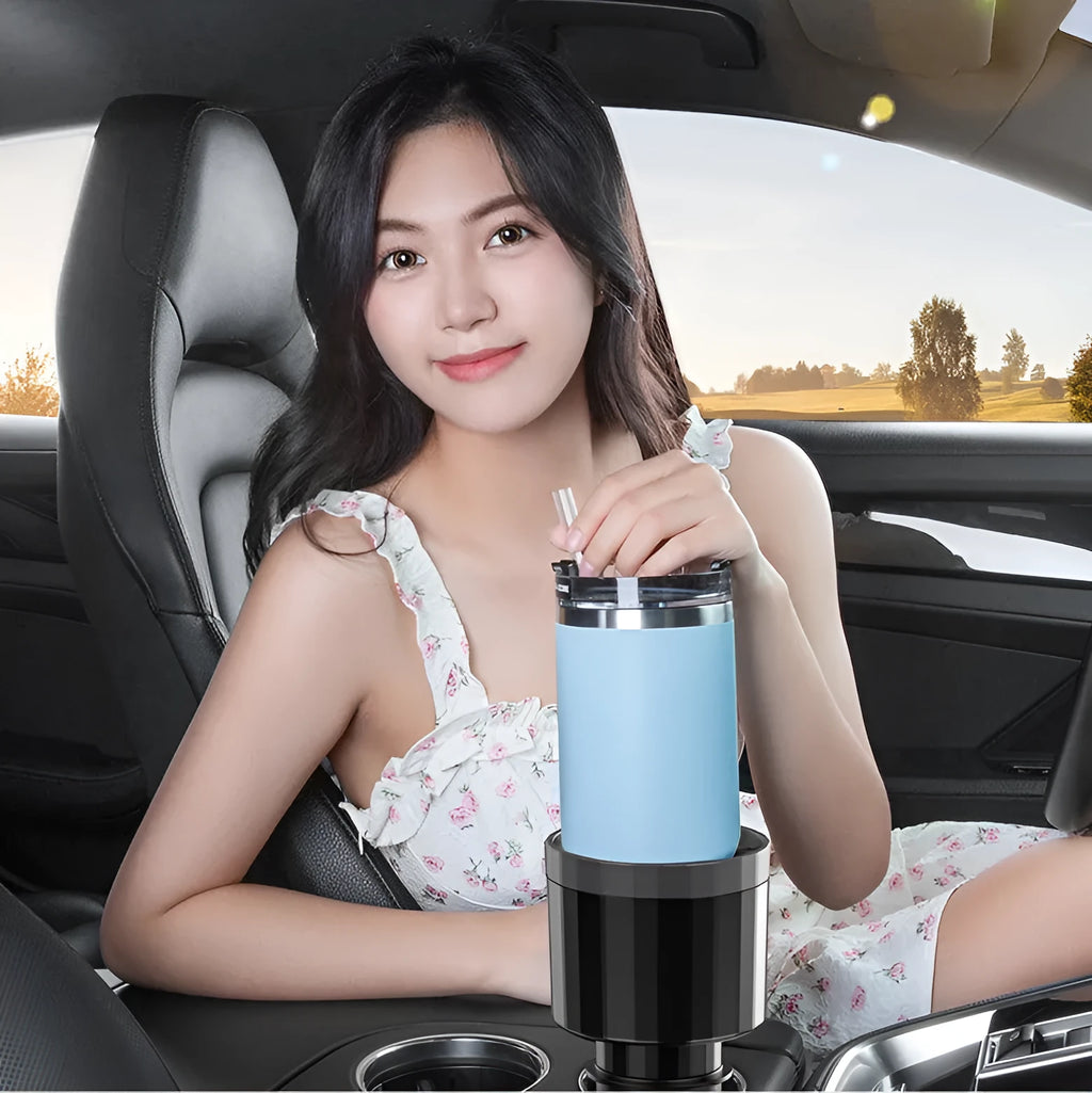 Matte black car cup holder expander with adjustable base for large bottles.