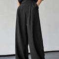 Black men's trousers with vertical striped pleated design showing elastic casual wear