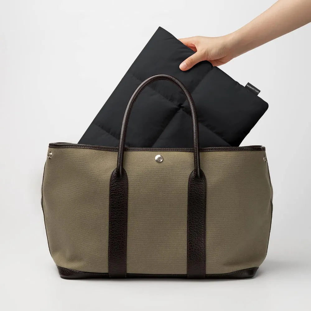 Soft fluffy black polyester laptop sleeve for 13 to 15.6 inch laptops with sewing thread details.