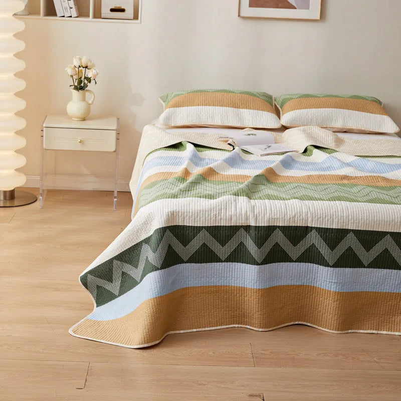 Pure cotton floral printed bed sheet and pillowcases laid flat on a bed.