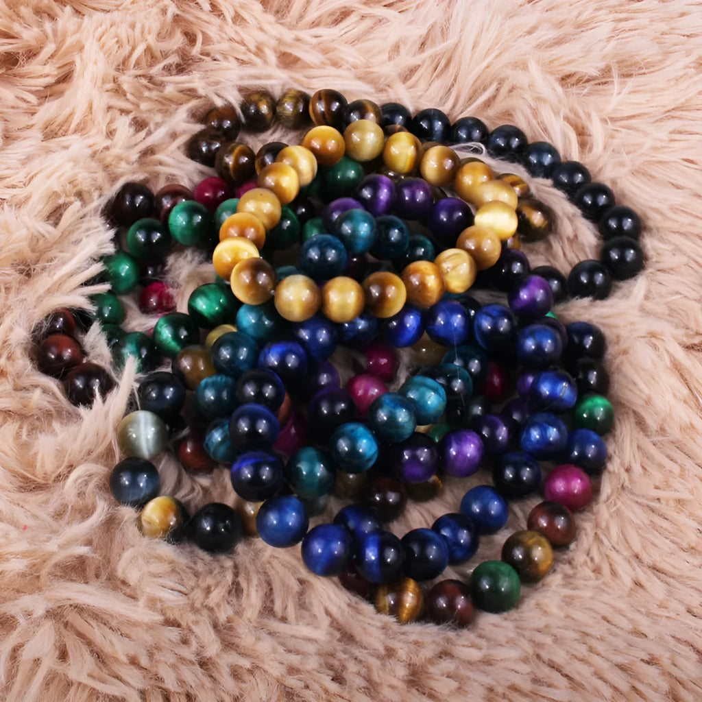 Natural tiger eye crystal bracelet with round beads in multiple colour options on a wrist.