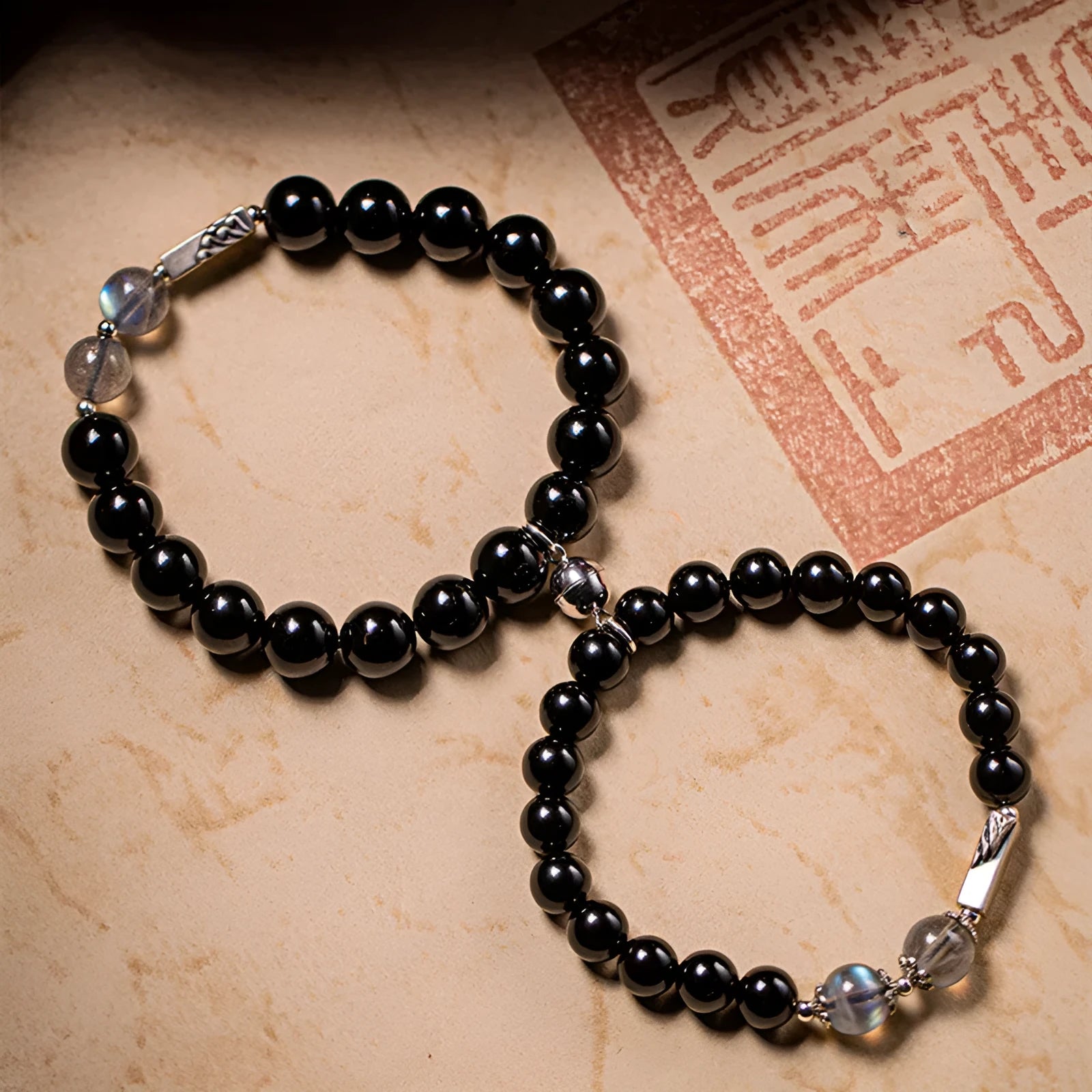 Obsidian Buddha beads couple bracelet DIY set showing 10mm men's and 8mm women's beads with national style patterns