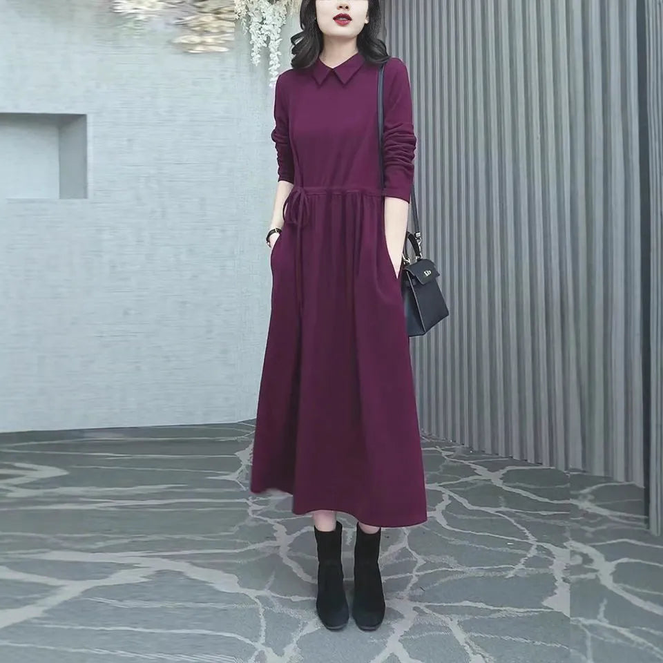 A purplish red plus size long sleeve dress for women, featuring a long skirt and urban commute style.