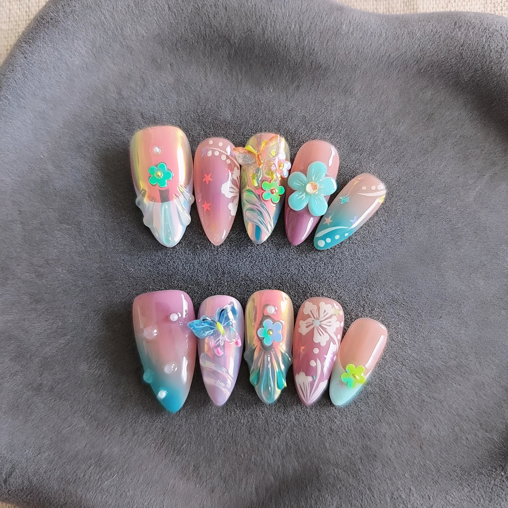 Handmade embossed nail art stickers showing floral and butterfly patterns in almond shape