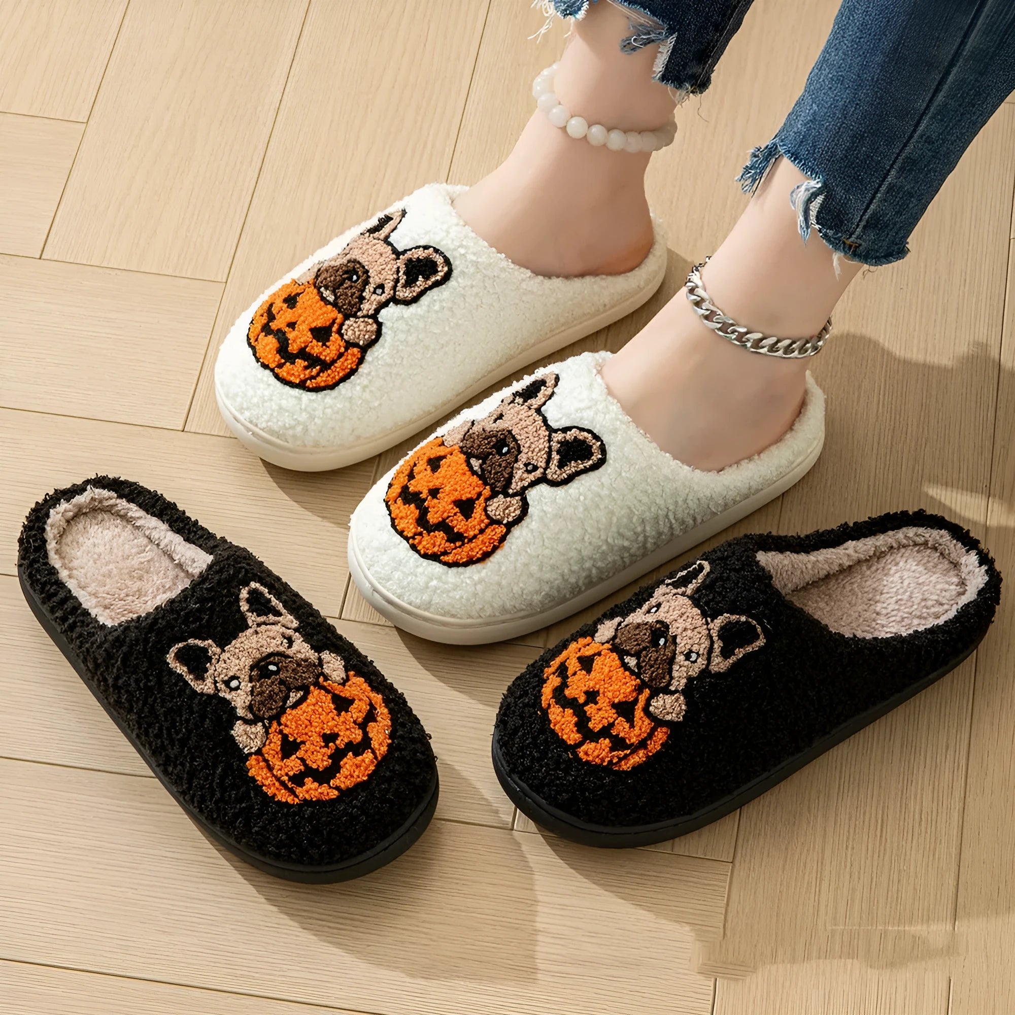 Halloween pumpkin design house slippers with plush cotton upper and TPR rubber sole in black and white.