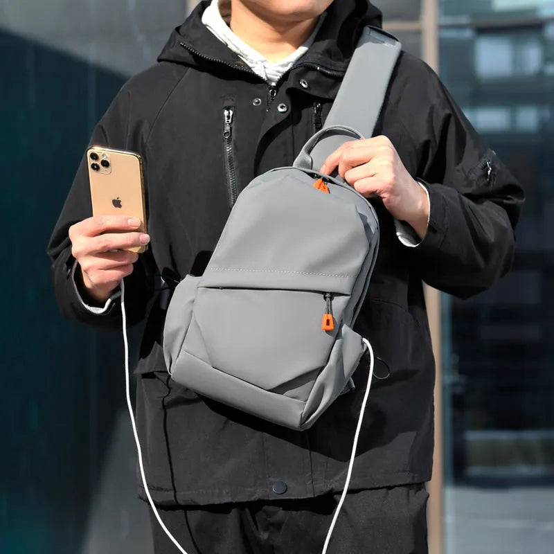 Men's black waterproof polyester crossbody bag worn across the body