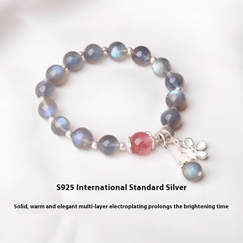 Silver grey women's bracelet with honeysuckle pattern, moonlight crystals, and a small zodiac charm.