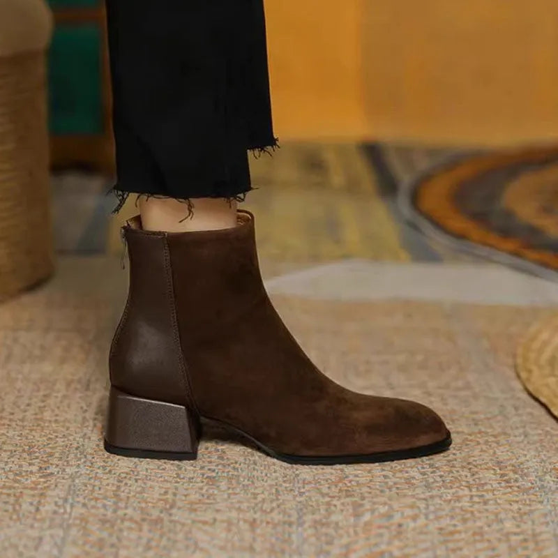 Women's suede martin boots in black with block heel and back zipper on a white background