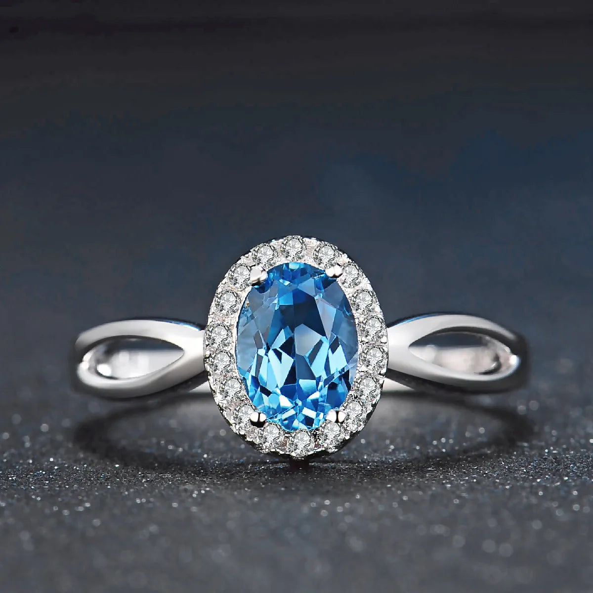 Women's 925 sterling silver and blue topaz four-piece jewellery set with geometric design, showing earrings, ring, necklace, and pendant.