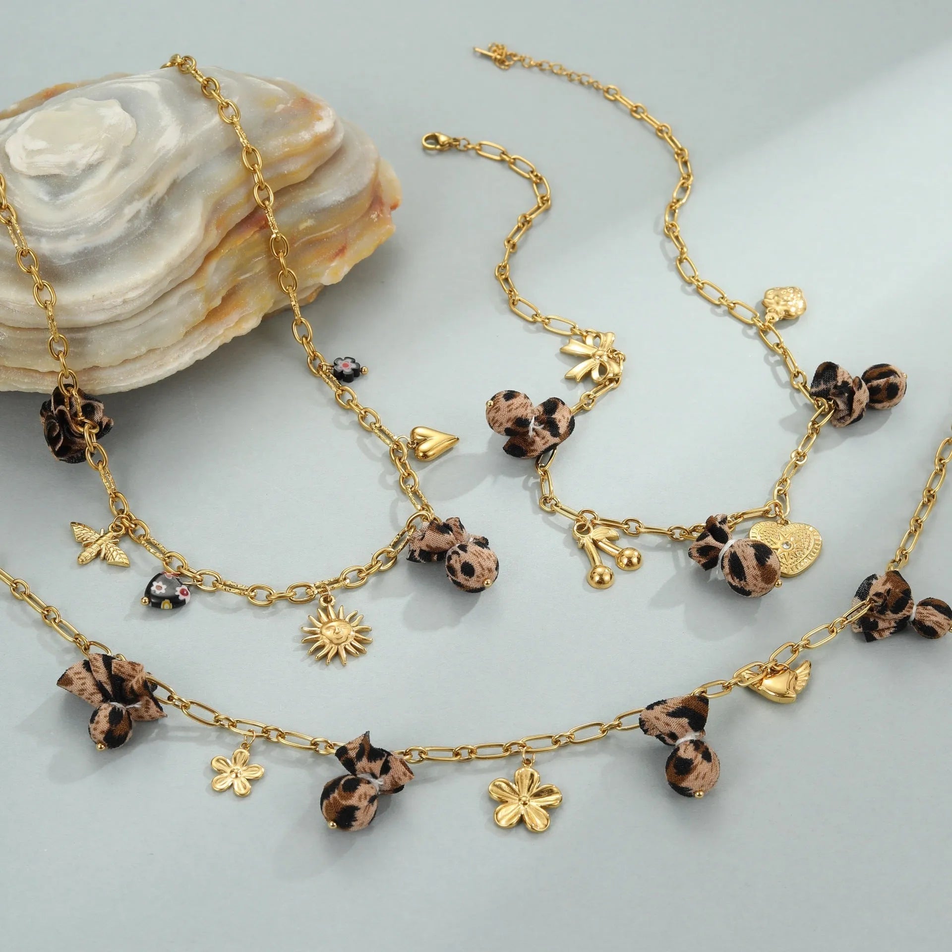 Stainless steel necklace with leopard, heart and flower pendant on adjustable chain
