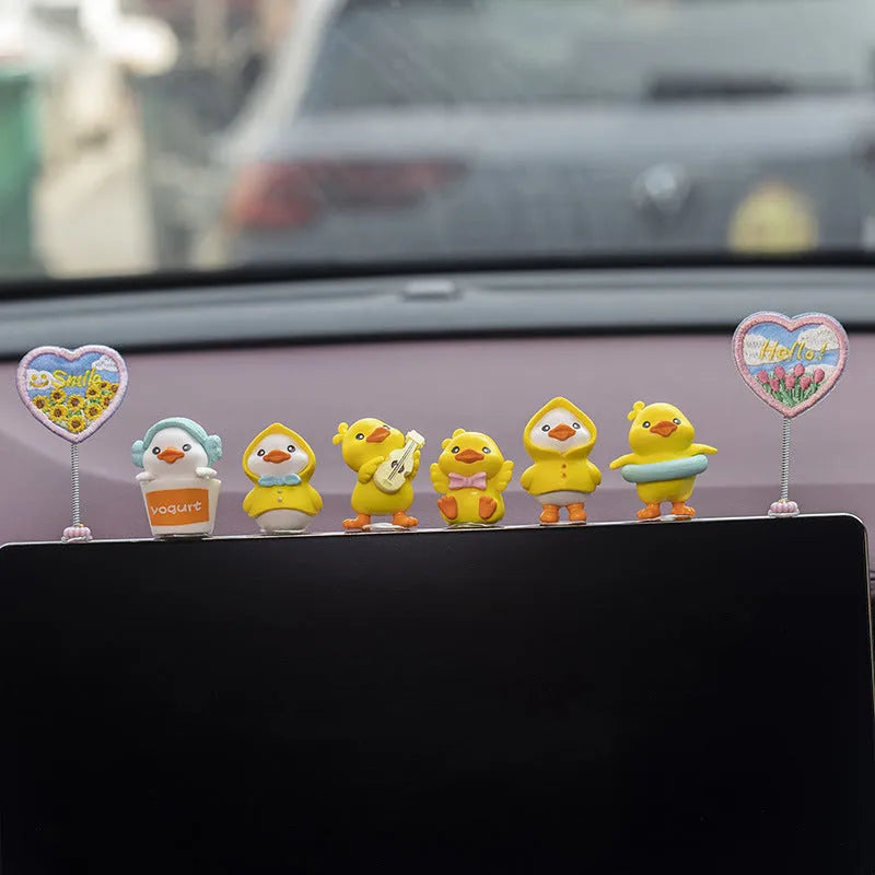 Set of six small PVC cartoon duckling figurines and one rectangular sign for car interior decoration