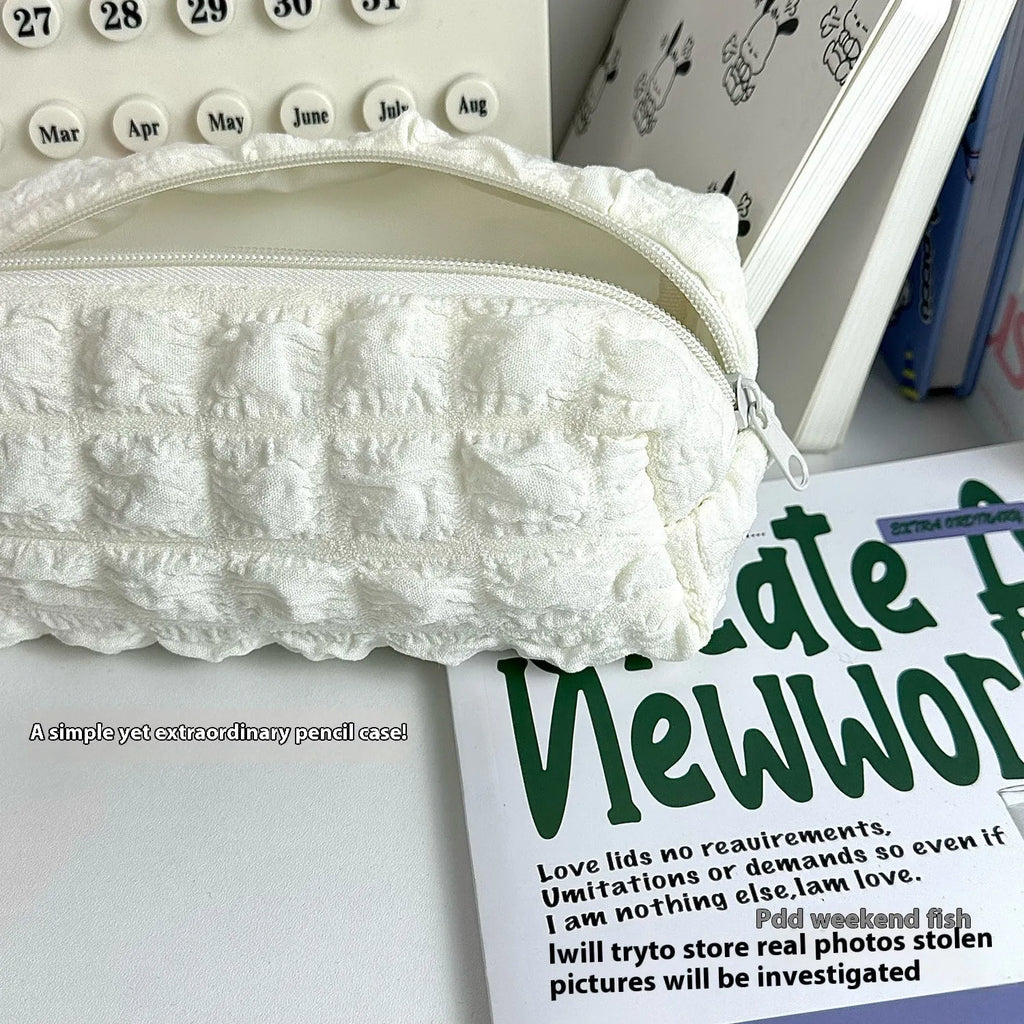 Beige fabric pencil case with cream puff design and zip closure for pens and stationery