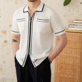Slim fit lapel collar short-sleeved polo shirt in black, laid flat.
