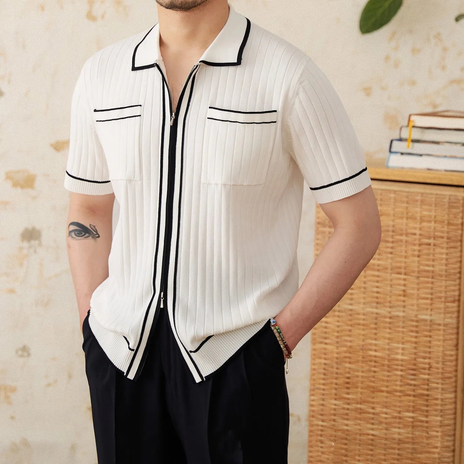 Slim fit lapel collar short-sleeved polo shirt in black, laid flat.
