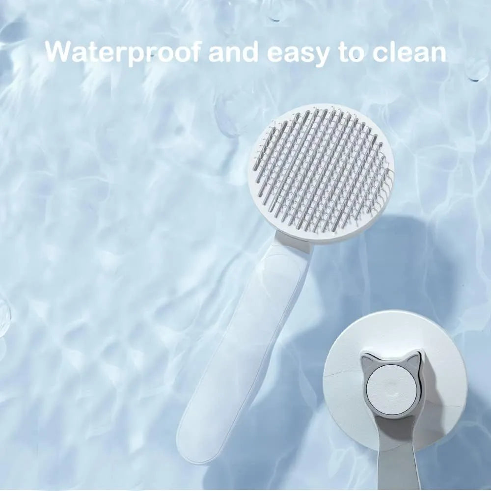 Blue self-cleaning cat brush with rubber handle and metal pins for removing loose pet fur.