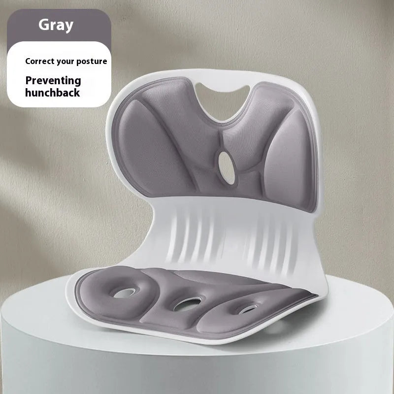Grey memory foam seat cushion with a black fabric fixing strap on a wooden chair.