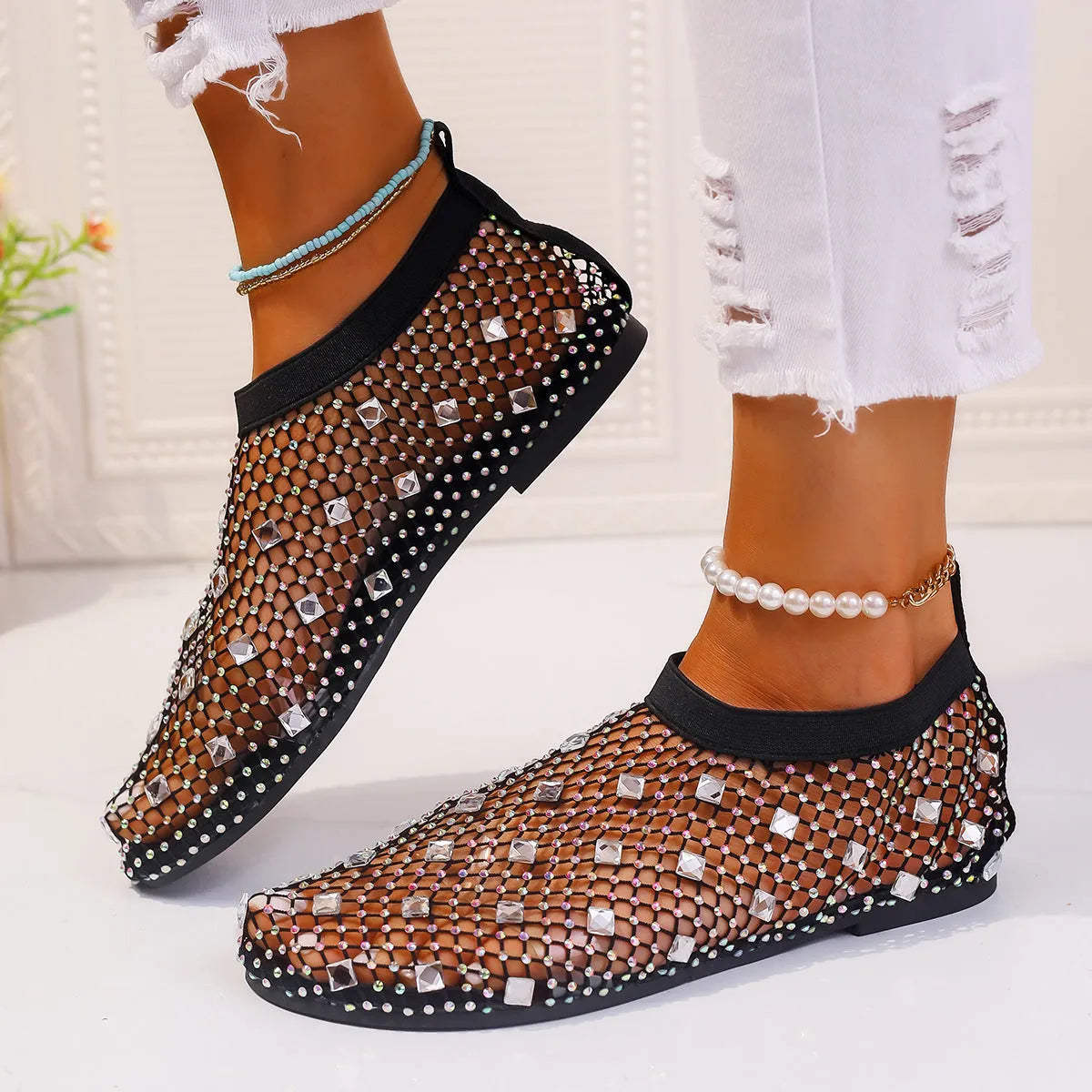 Colourful rhinestone detail on women's mesh flat sandals with round toe and rubber sole.