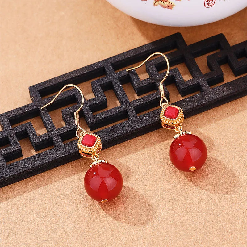 Geometric southern red agate and silver-inlaid jasper earrings with copper alloy posts.