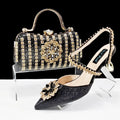 Women's black high heel and matching clutch bag set with rhinestone floral decoration and pointed toe.