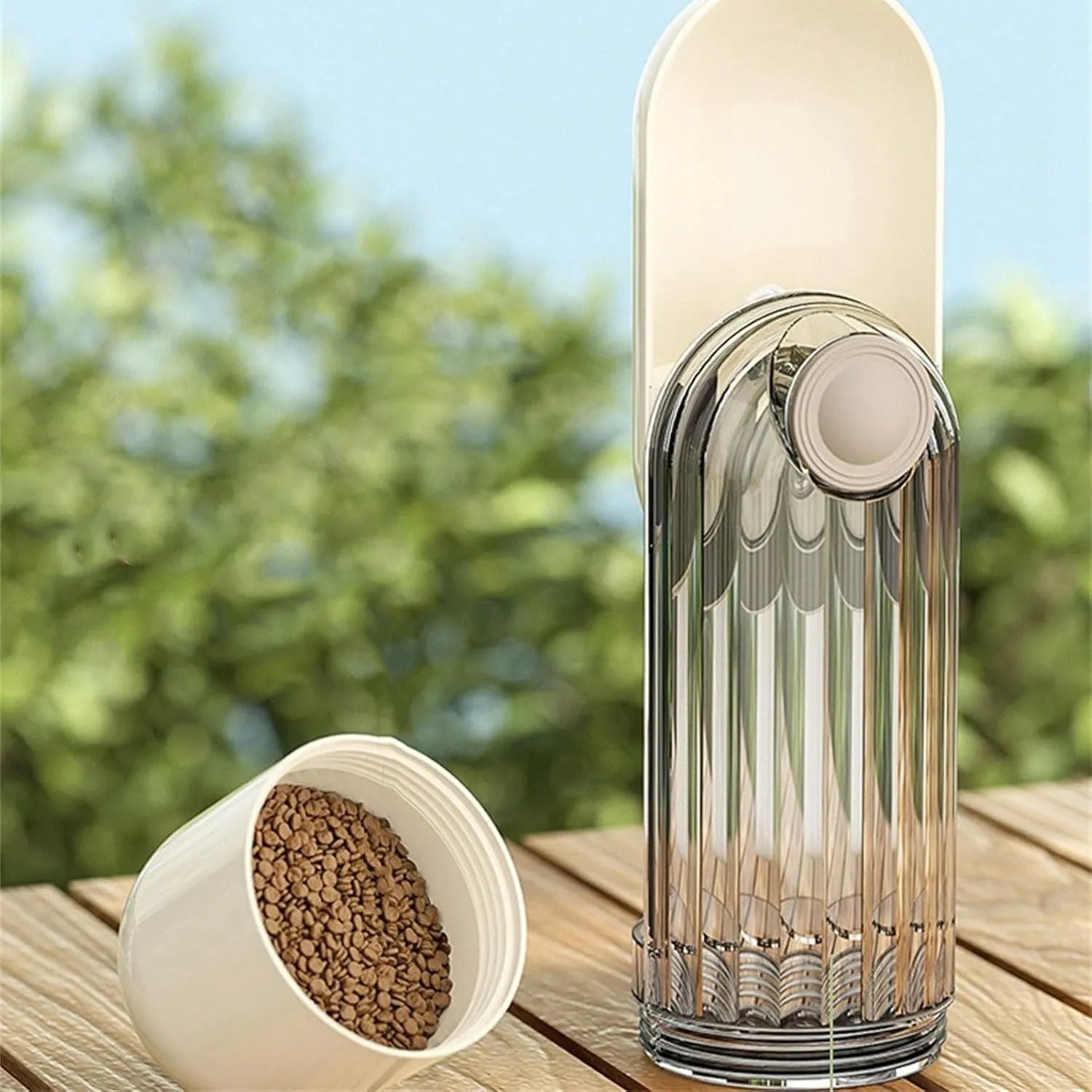 Green foldable dog water bottle with leak-proof lid and food container, shown extended for use.